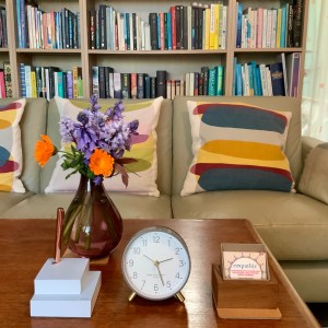 Showing the therapy room’s clock, notes, business cards with a vase full of flowers from my garden