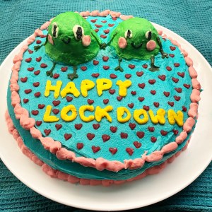 Happy Lockdown teen cooking covid lockdown cake with icing frogs