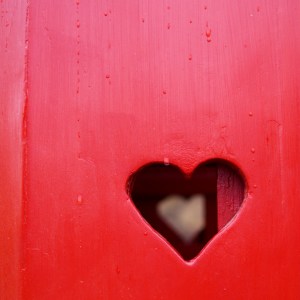 Red heart cutout in a gate, symbolising empathy, being an empathic therapist