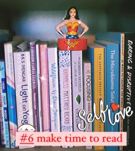 Grainy iphone photo of books and Wonder Woman statue