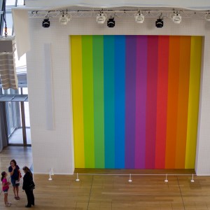 Family talking in front of a large rainbow curtain LBGTQ questioning is a normal part of adolescence